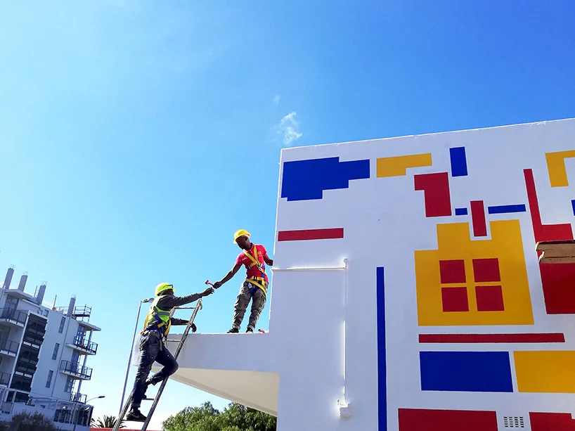 Together : A team of skilled painters was assembled to work closely with Lorenzo Nassimbeni in the installation of the mural.