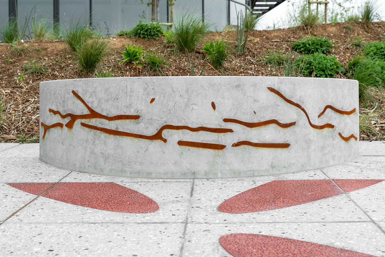 A view showing the steel drawing representing the Highveld landscape cast into the concrete of the seat