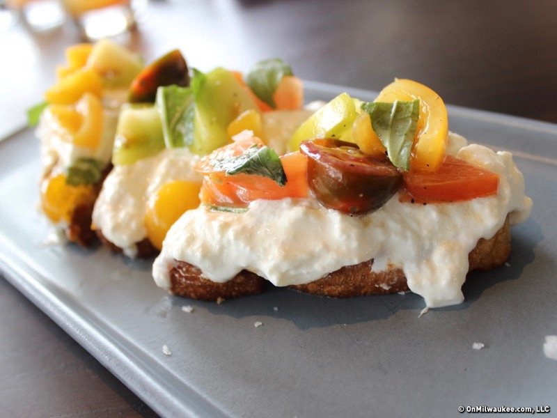 Fresh burrata served with heirloom tomatoes, white balsamic and basil.