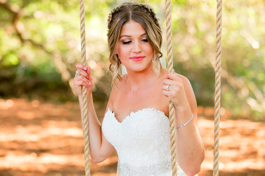 Wedding Hairstyle with Braided updo and Natural Makeup. Photos taken outside on Swing. Bridal hair and makeup by Vanity Belle in Orange County (Costa Mesa) and San Diego (La Jolla)