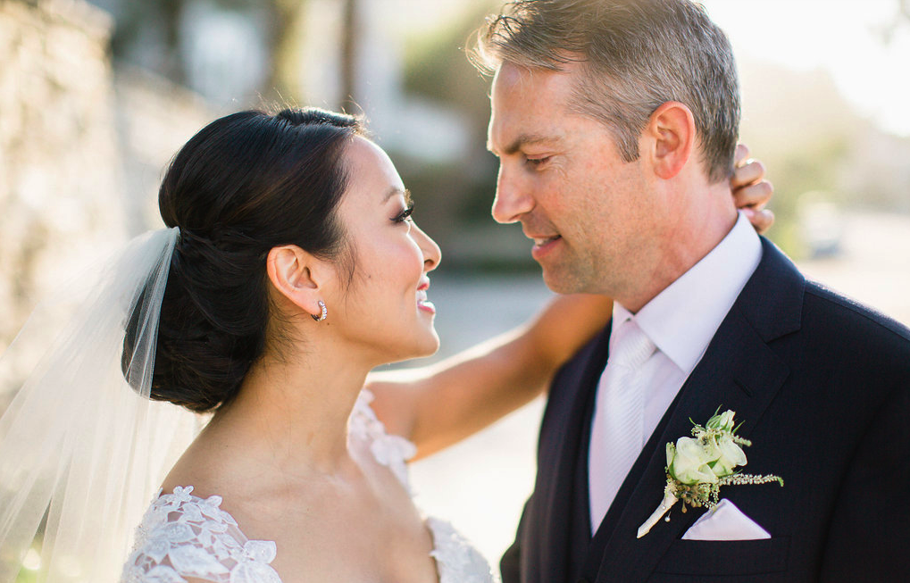 Asian Bride with Updo Hairstyle and Veil Looking Into Husband's Eyes in Wedding Photos. Bridal Hair and Makeup by Vanity Belle in Orange County (Costa Mesa) and San Diego (La Jolla)