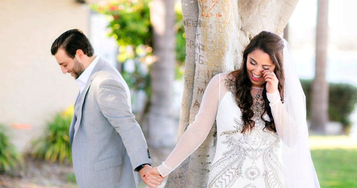 Wedding Photography with Couple Smiling Holding Hands Outdoors. Bridal Hair and Makeup by Vanity Belle in Orange County (Costa Mesa) and San Diego (La Jolla)