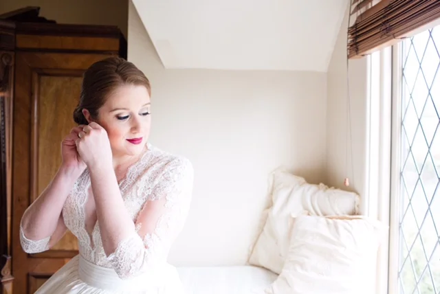 Wedding Morning Photos with Bride Putting on Jewelry. Bridal hair and makeup by Vanity Belle in Orange County (Costa Mesa) and San Diego (La Jolla)