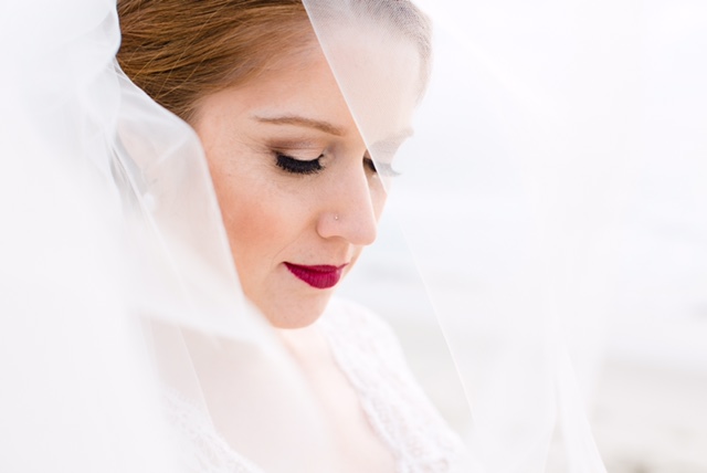 Wedding Day Photo with Redhead Bride in Veil Wearing Red Lipstick and Eyelash Extensions. Bridal Hair and Makeup by Vanity Belle in Orange County (Costa Mesa) and San Diego (La Jolla)