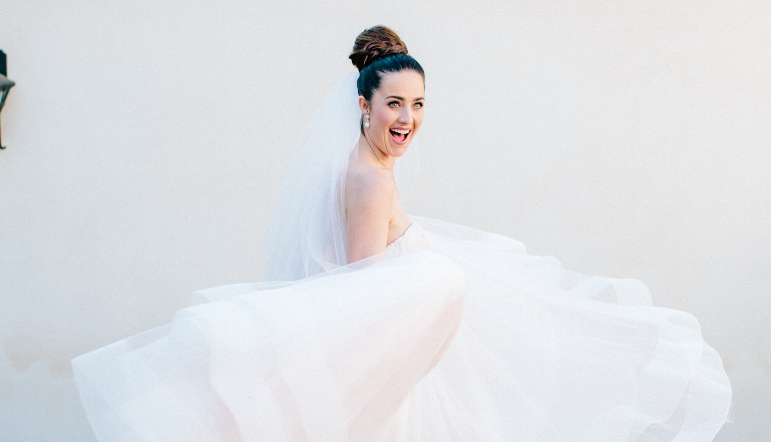 Brunette Bride Twirling Dress with Braid Updo and Veil + Makeup for Blue Eyes. Bridal beauty by Vanity Belle in Orange County (Costa Mesa) and San Diego (La Jolla) 