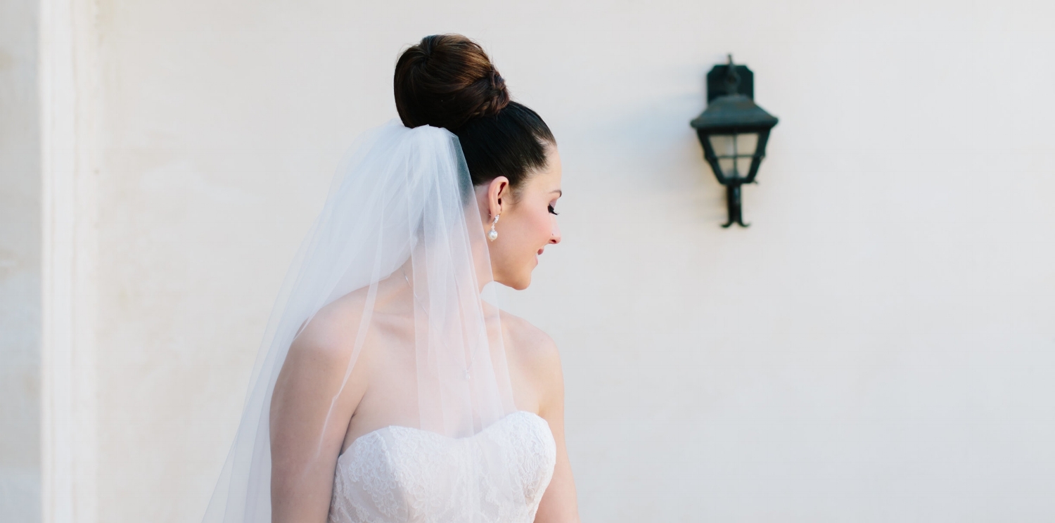 Brunette Bride with Braid Updo and Veil + Makeup and Eyelash Extensions. Bridal beauty by Vanity Belle in Orange County (Costa Mesa) and San Diego (La Jolla) 