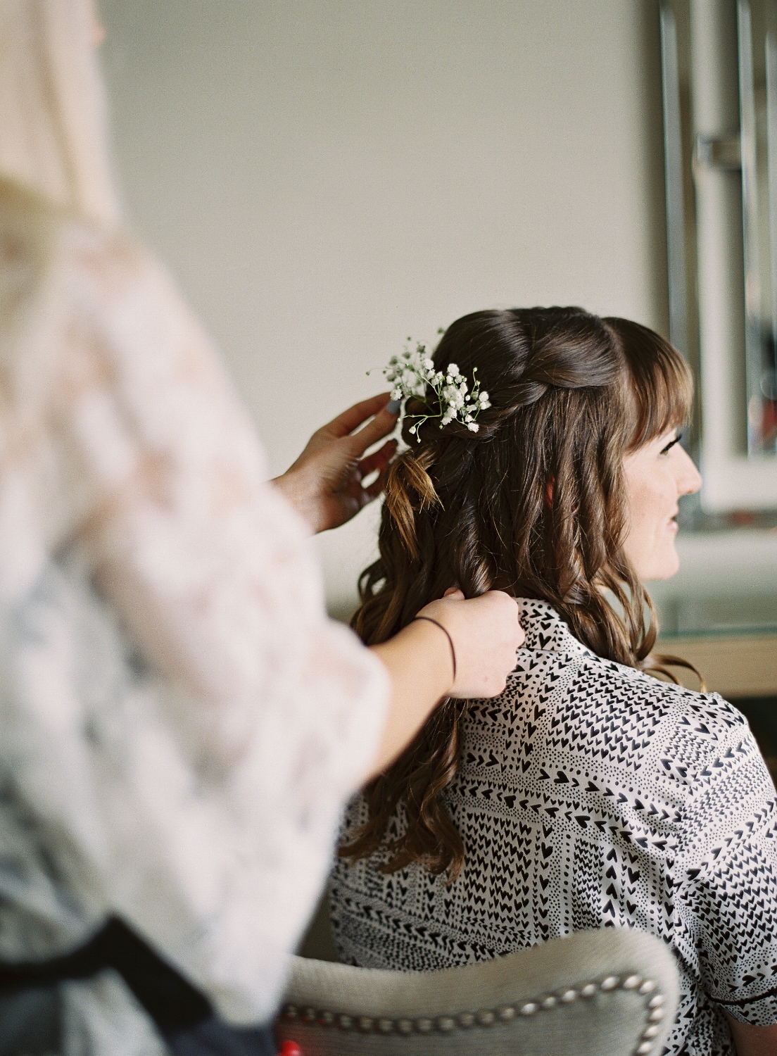 Brunette Bride with Curled Hairstyle Down, bangs and flowers in hair. Wedding makeup and hair by Vanity Belle in Orange County (Costa Mesa) and San Diego (La Jolla)