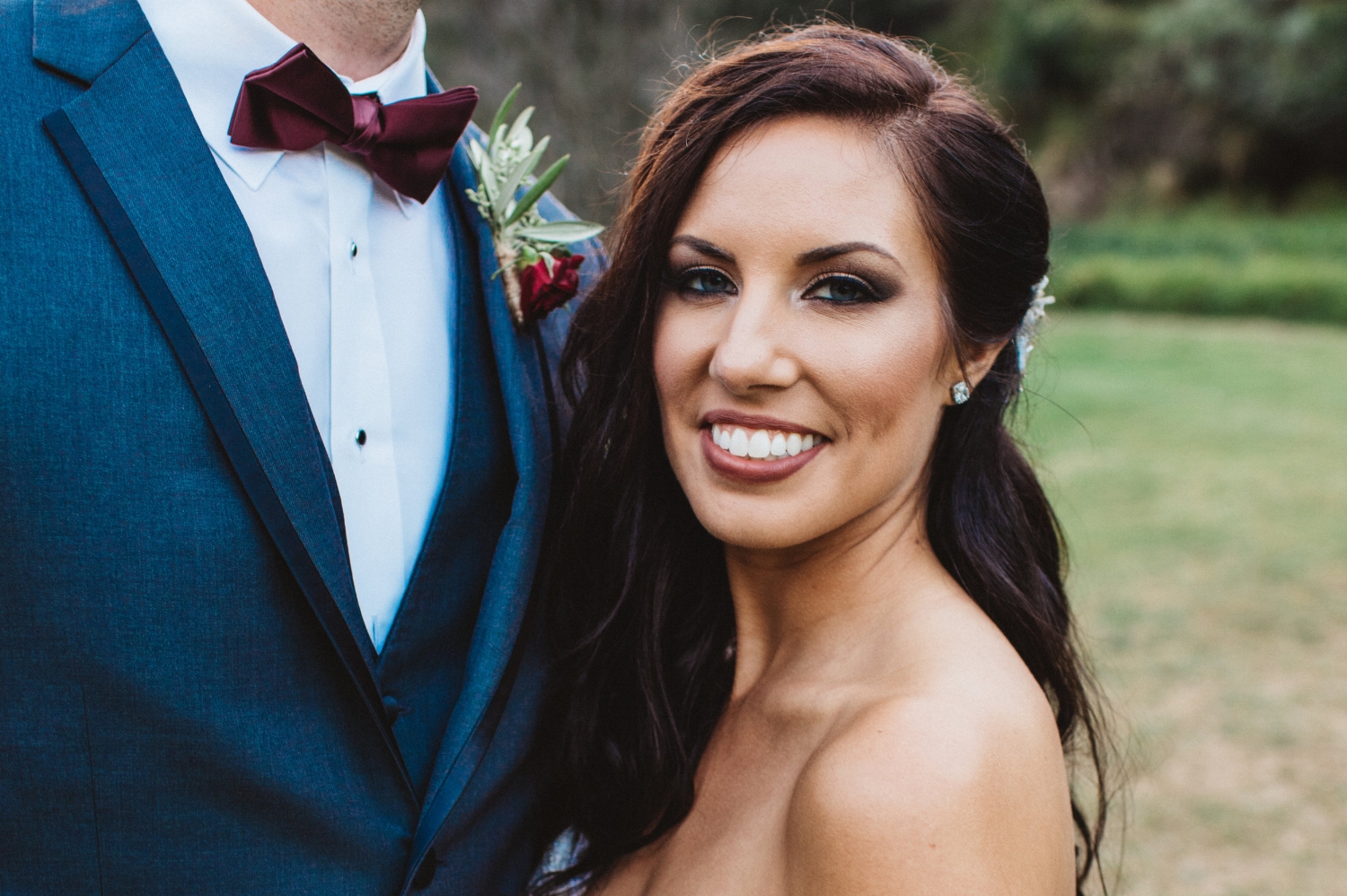 Brunette Bride with Long Hairstyle Down and Smokey Eye Makeup in Outdoor Wedding Photos. Bridal hair and makeup by Vanity Belle in Orange County (Costa Mesa) and San Diego (La Jolla)