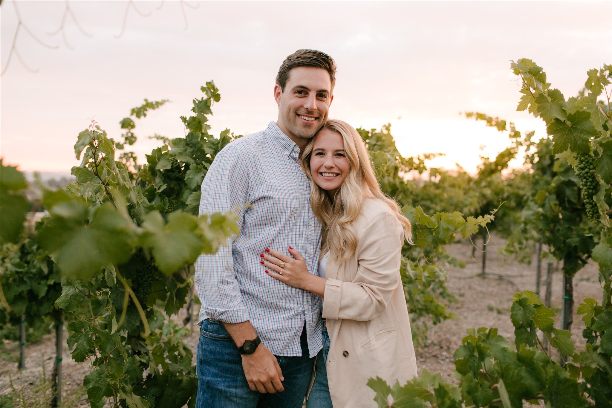 couple smiling in vineyard