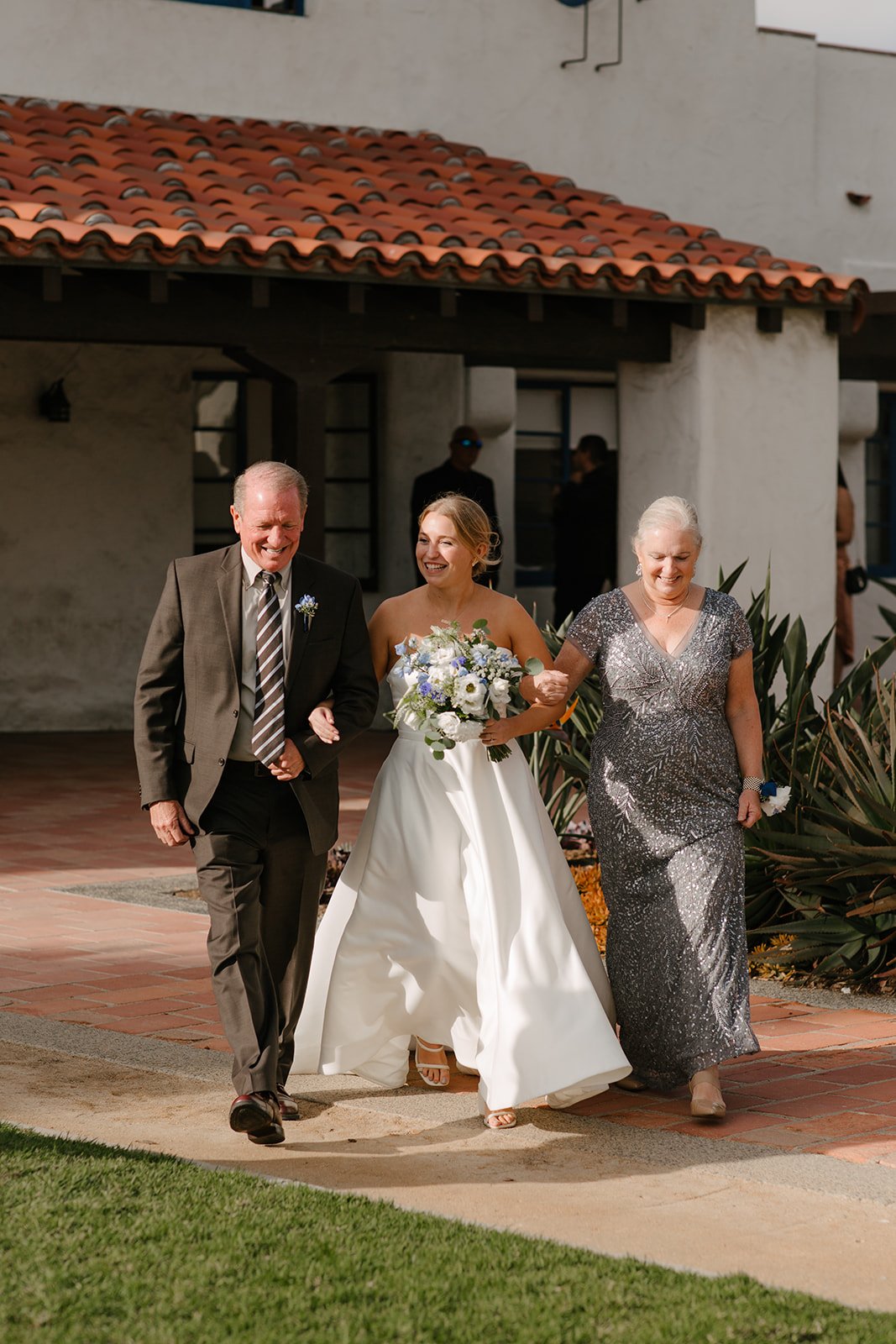 bride walking in with parents
