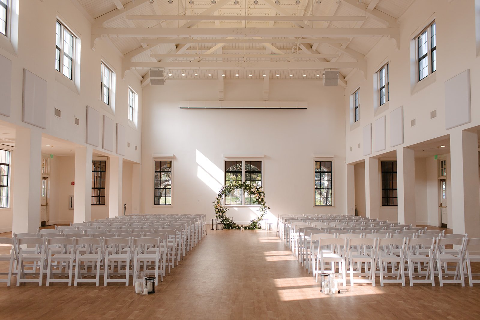 modern-southern-california-wedding-venue-moniker-events-building-177-white-walls-chairs-floral-arch