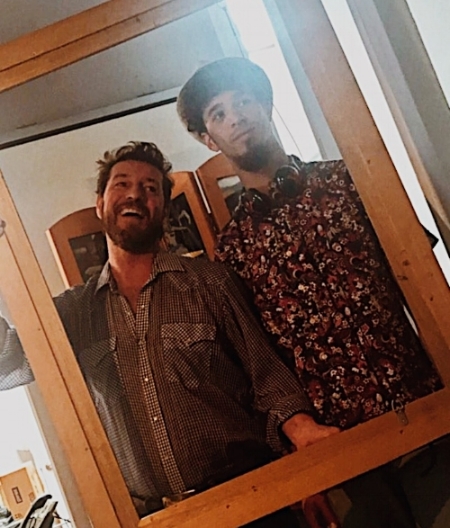 premiere event's brian & Jacques posing by unfinished photo frame 