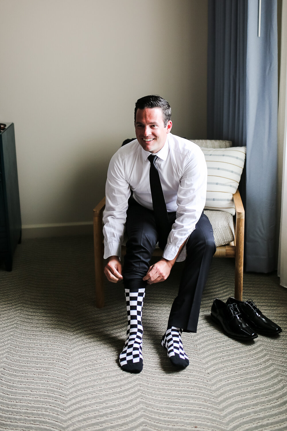 groom getting ready with shoes