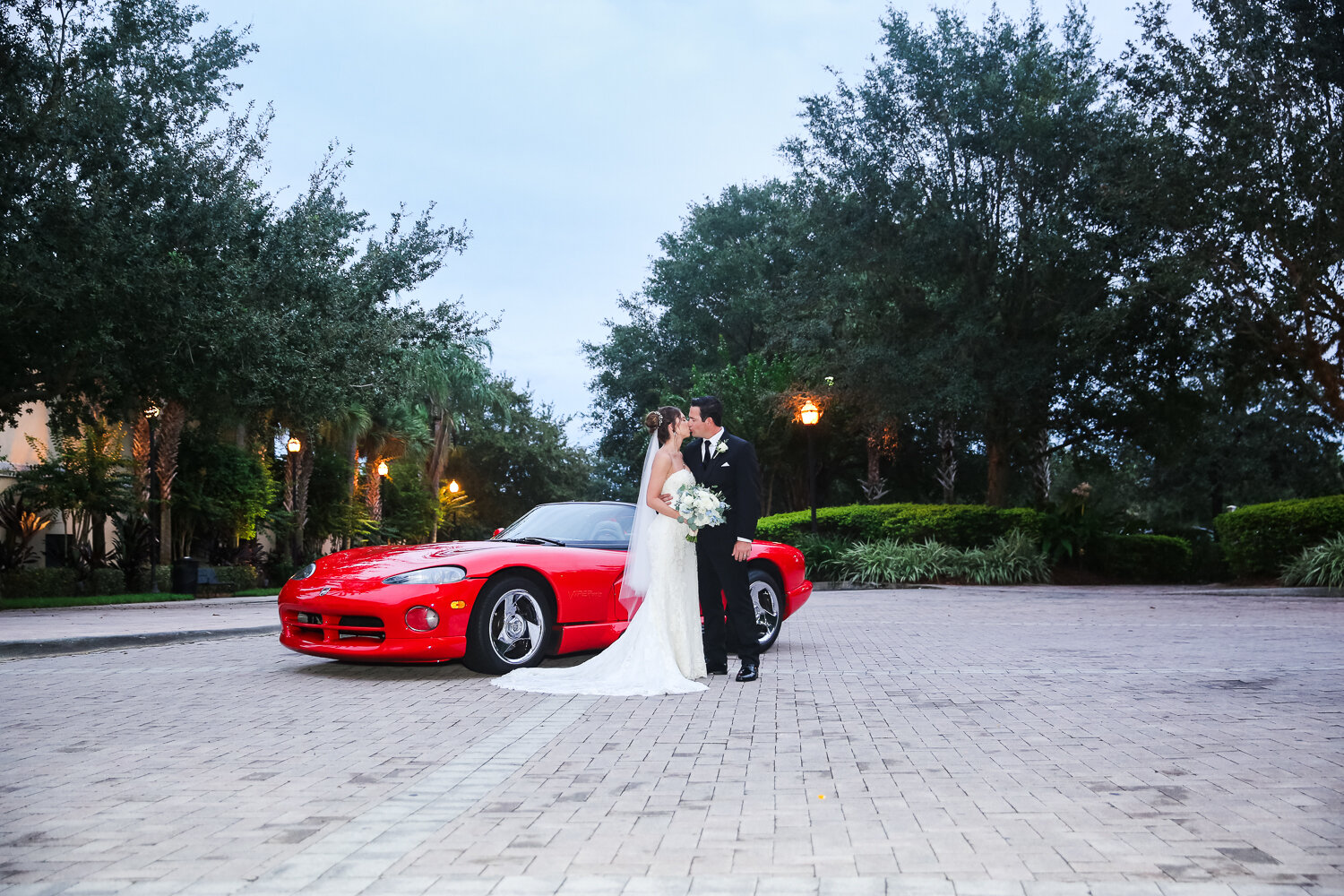 bride and groom portrait with viper car
