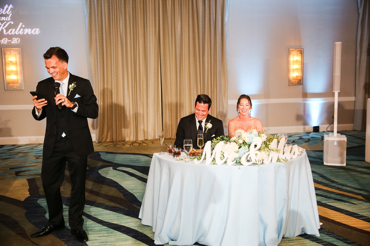 bride and groom laughing with speeches