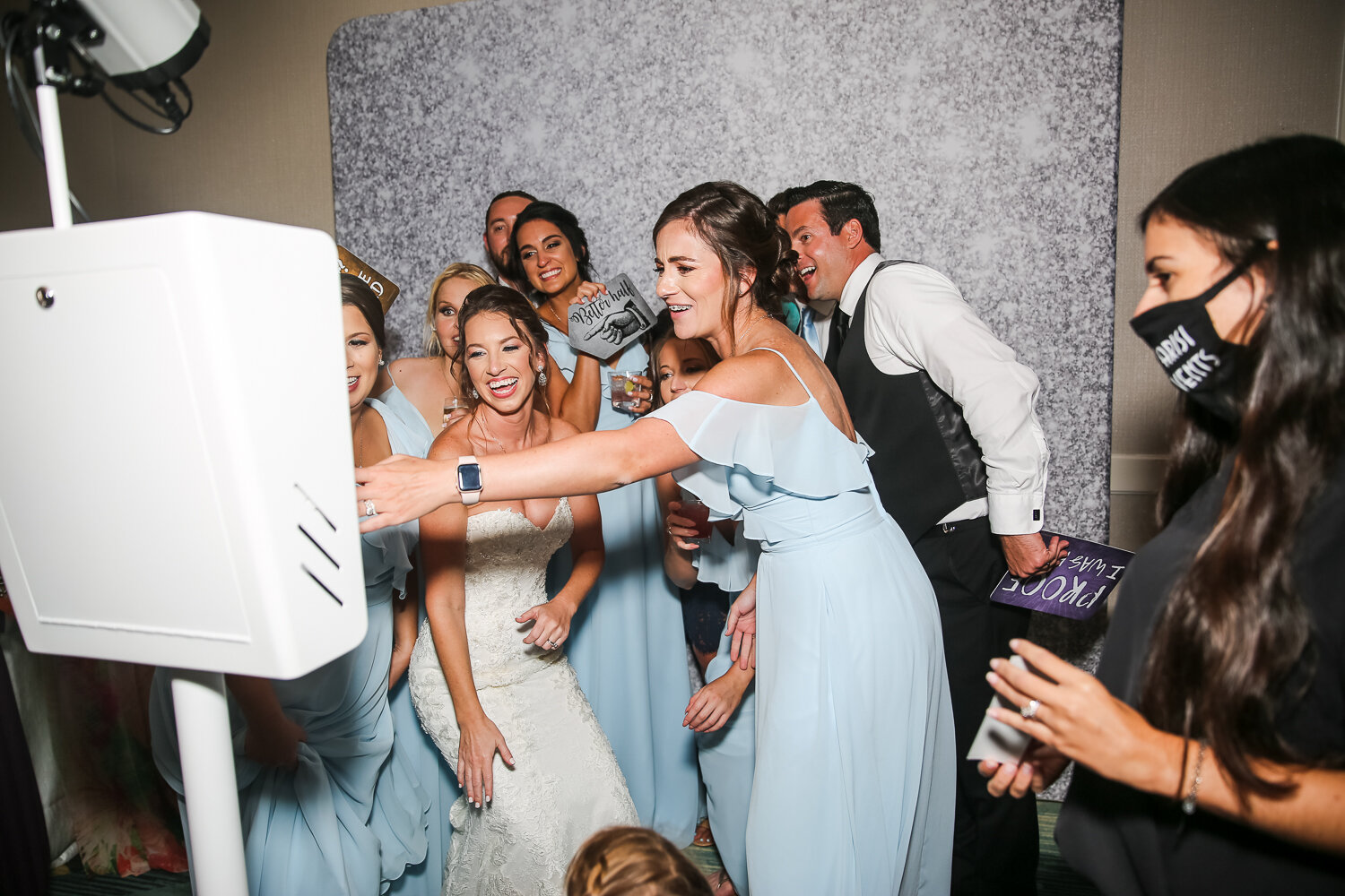 bride and groom laughing with photo booth