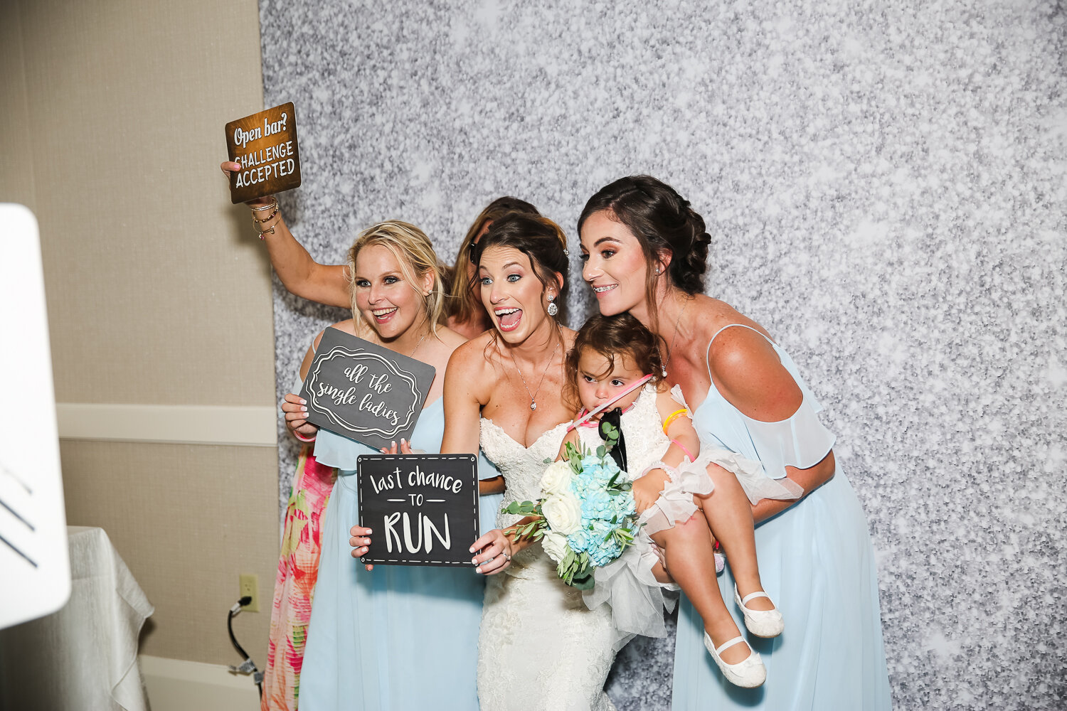 bride and bridesmaids with photo booth