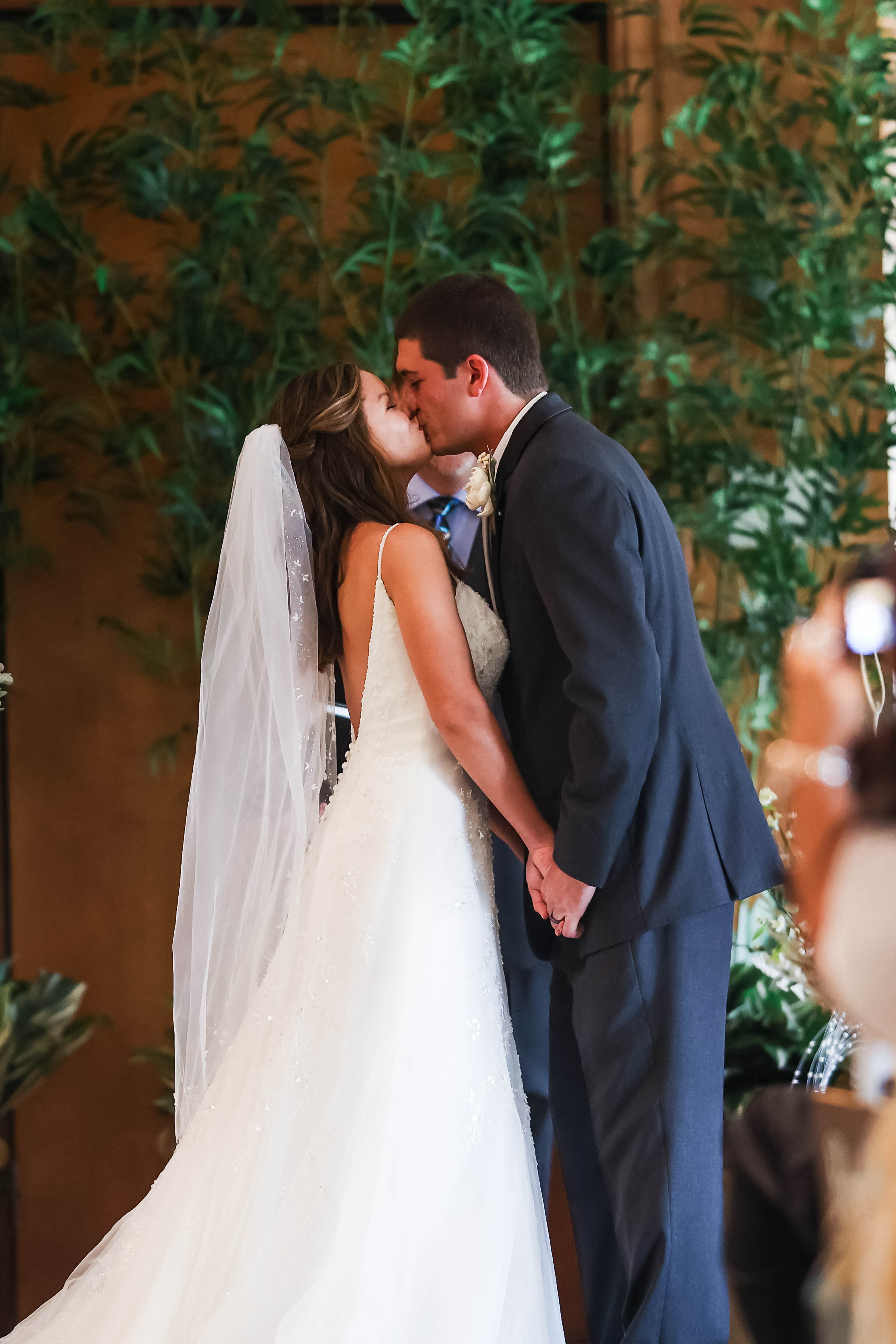 bride and groom at altar kissing