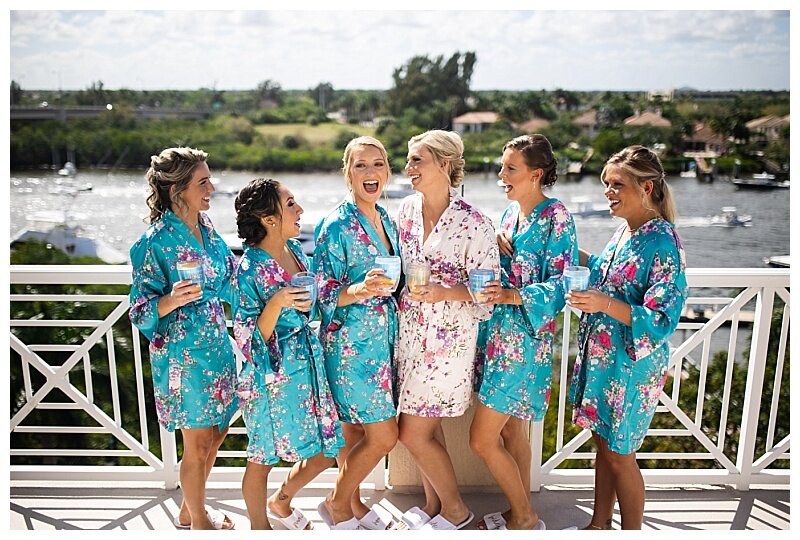 bridal party in robes by water