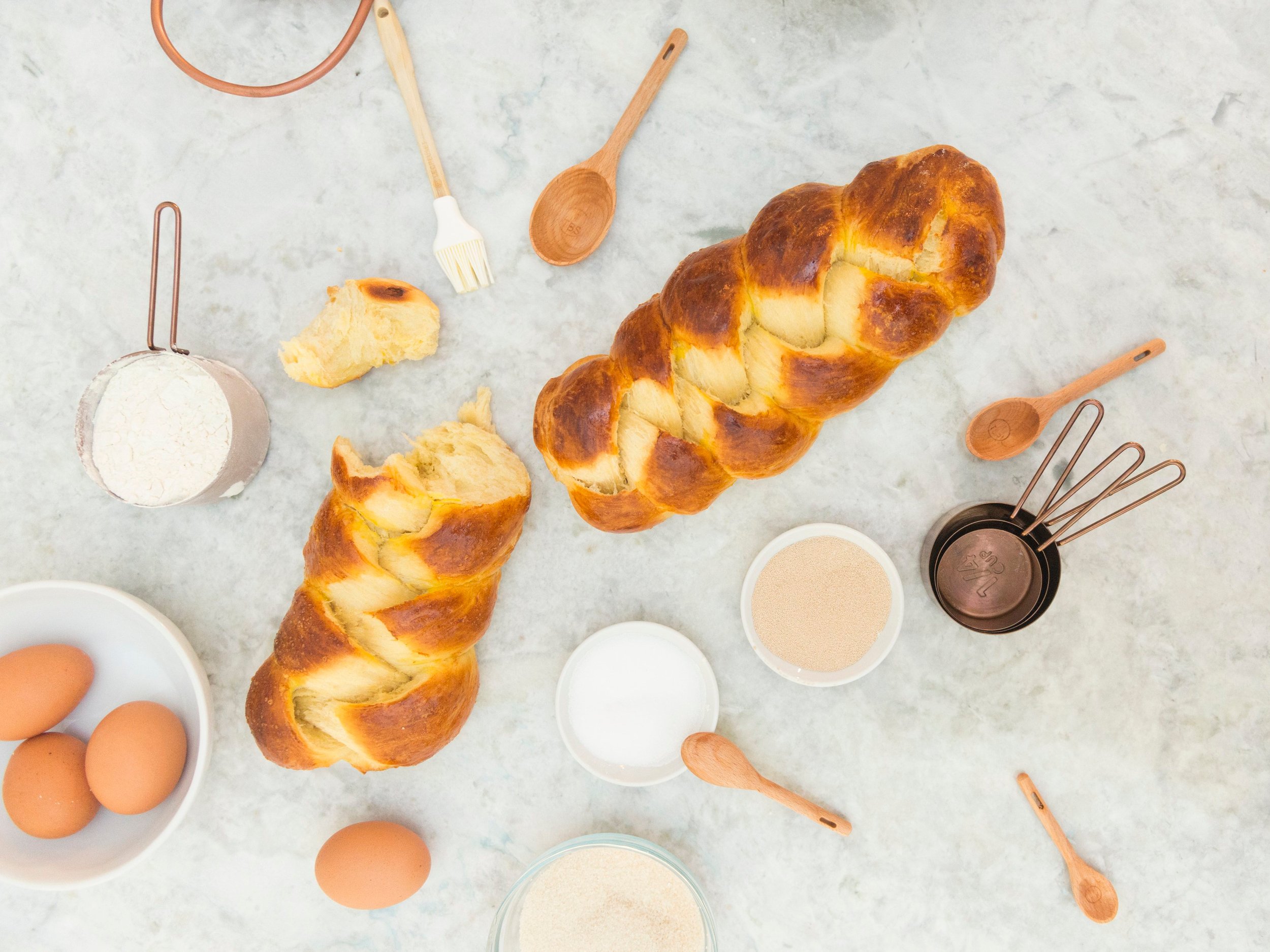 Baking loaves of challah, all of the ingredients