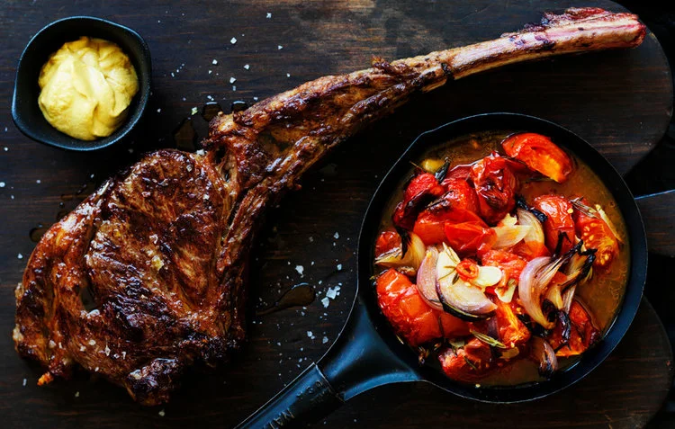 tomahawk steak and roast tomatoes with rosemary