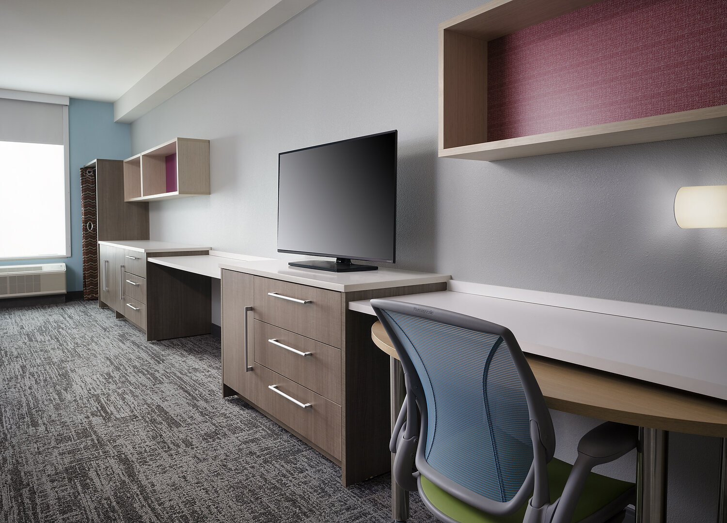 Pearl Home2suites 225 entertainment wall.JPG