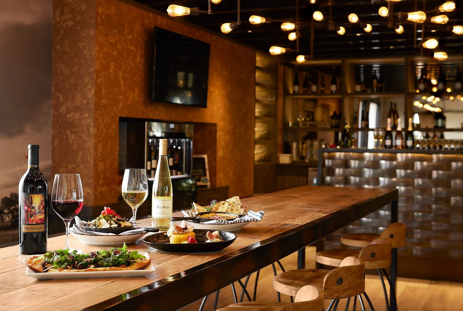 Santa Barbara Hilton wine room with food and bottles 2.JPEG