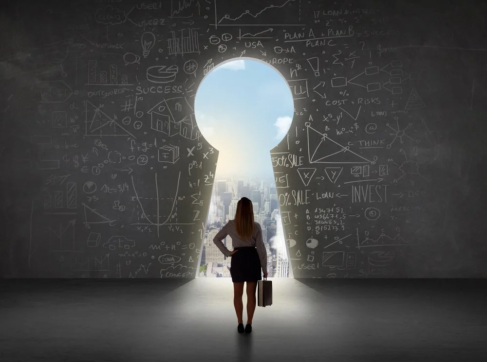 Business woman looking at keyhole with bright cityscape concept background.jpeg