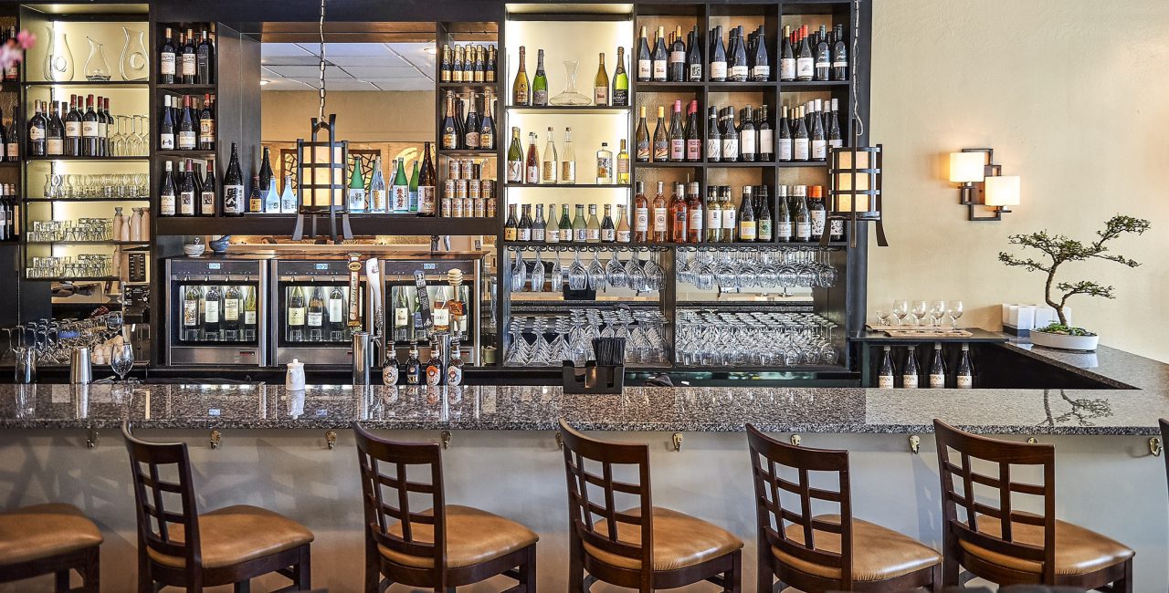 Quattro-model-behind-the-bar-with-12-bottles.jpg