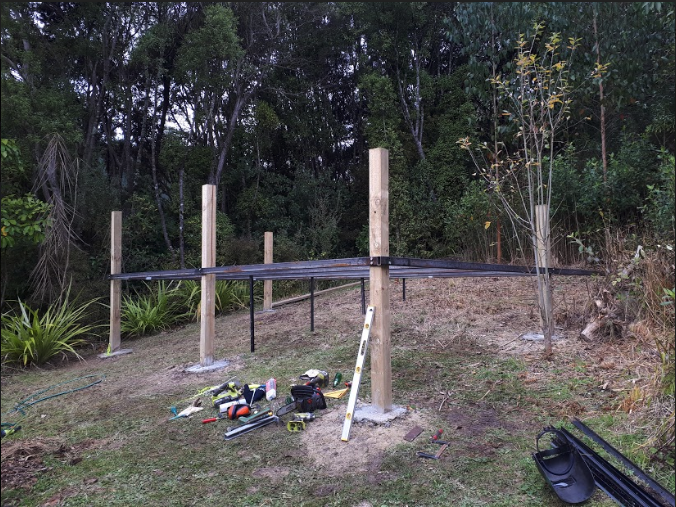 After cementing the posts in the ground we then secured the steel.