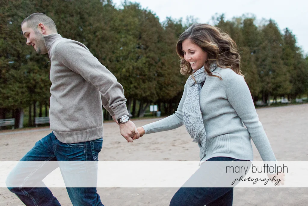 Couple frolic in the park at Skaneateles Engagement