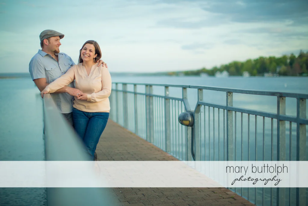 Couple enjoy the view from the dock at Skaneateles Engagement
