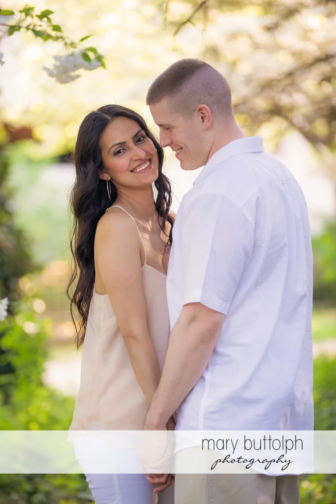 Couple hold hands on the lawn at Franklin Square Engagement