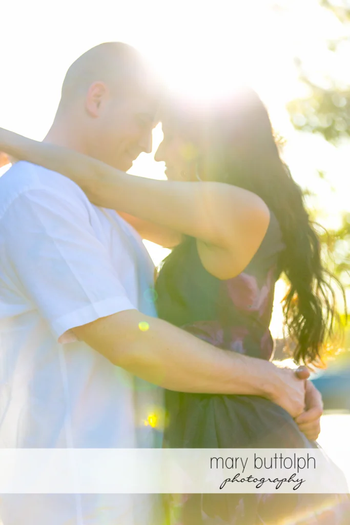 Couple embrace under the sun at Franklin Square Engagement