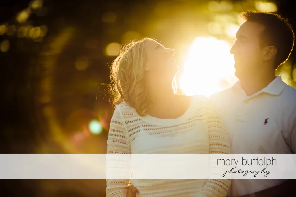 Couple catch the sun's rays in the garden at Skaneateles Engagement