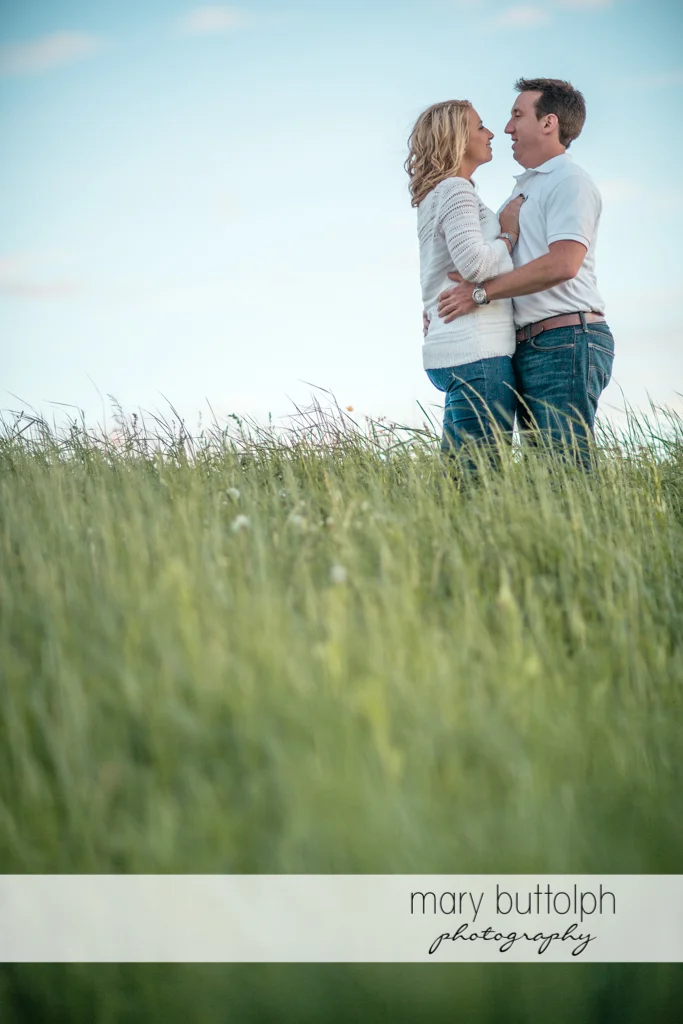 Couple pose in the field at Skaneateles Engagement