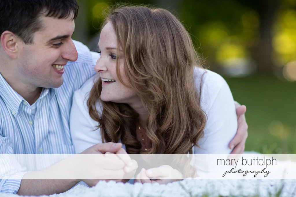 Couple relax on the lawn at Lourdes Camp Engagement