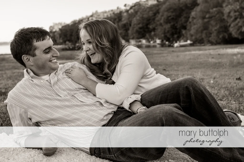 Couple lie on the grass at Lourdes Camp Engagement