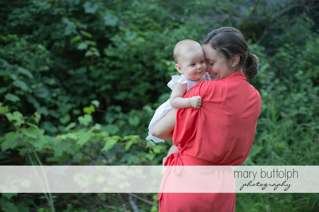 Woman carrying her baby in the garden at Skaneateles Family