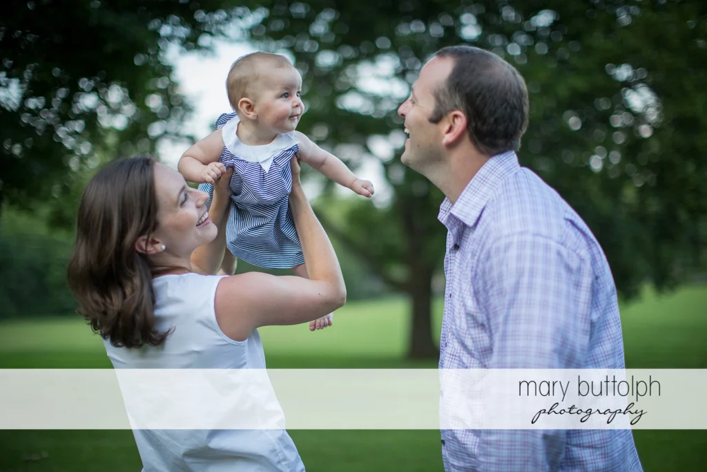 Couple have fun with their baby at Skaneateles Family