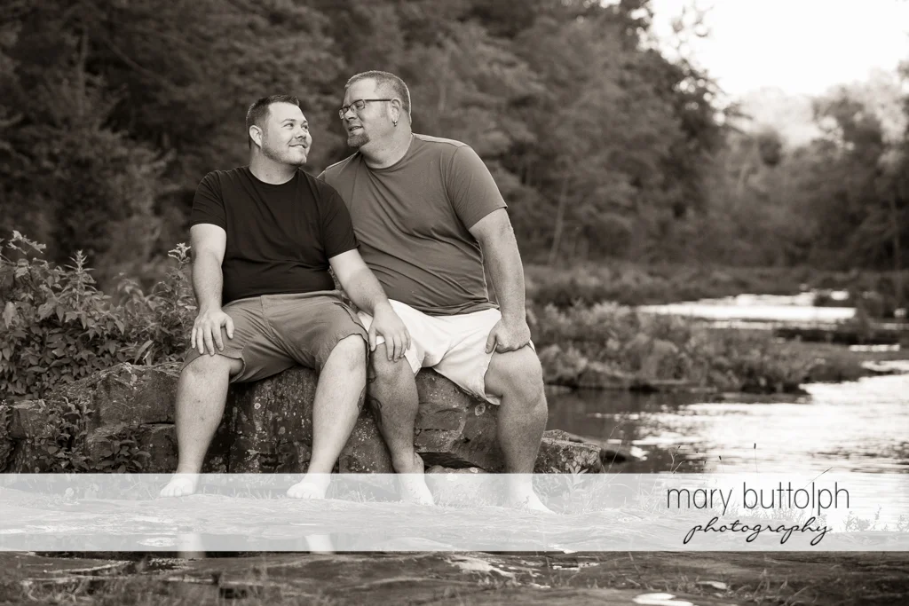 Same sex couple spend a quiet time at the river at Salmon River Falls Engagement