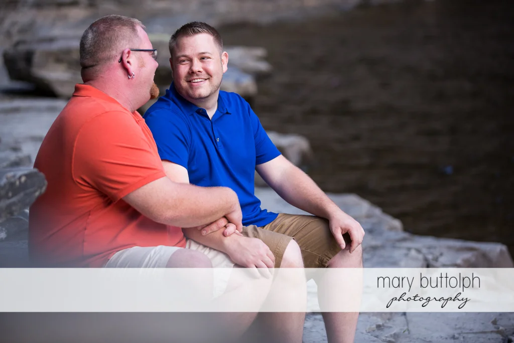 Same sex couple relax by the river at Salmon River Falls Engagement