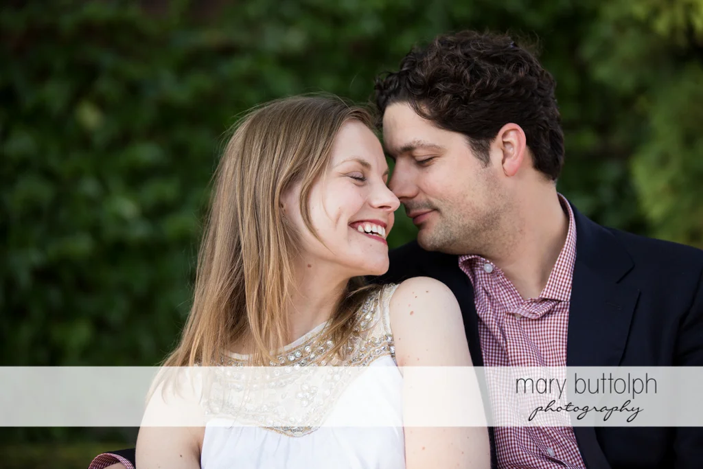 Couple in a romantic mood in the garden at Skaneateles Engagement