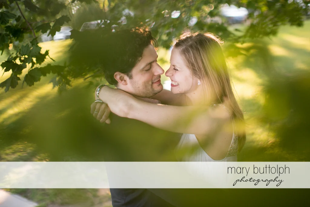 Couple embrace in the garden at Skaneateles Engagement
