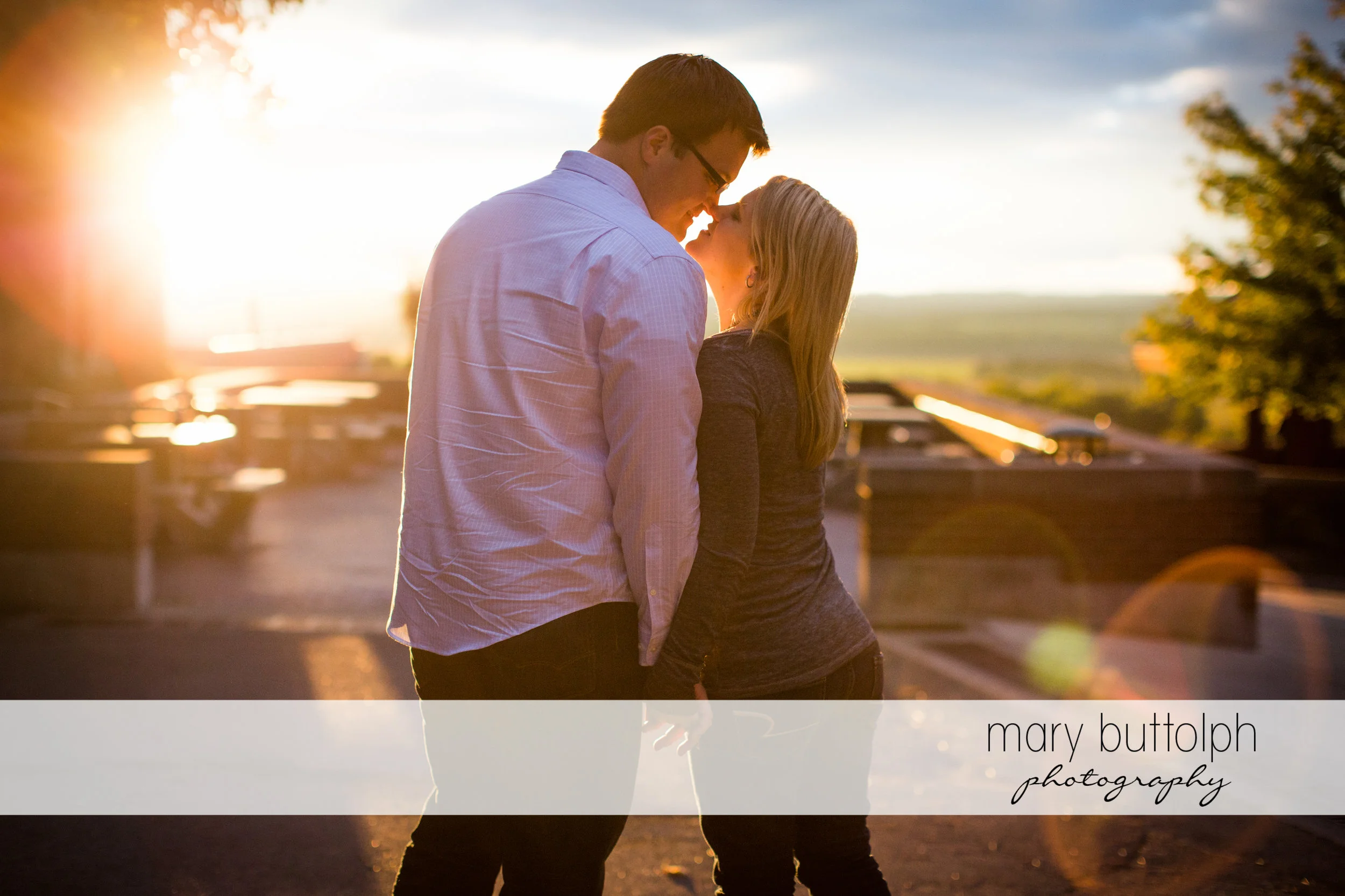 Couple rub noses in the sunset at SUNY Geneseo Engagement