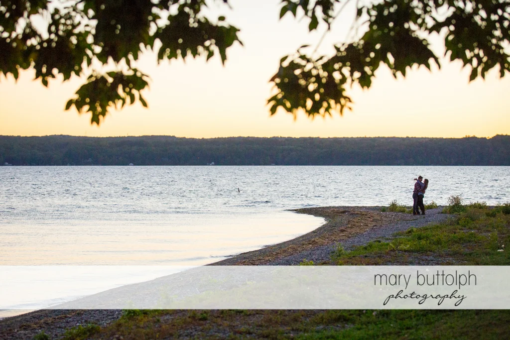 Couple pose near the lake at Aurora Engagement