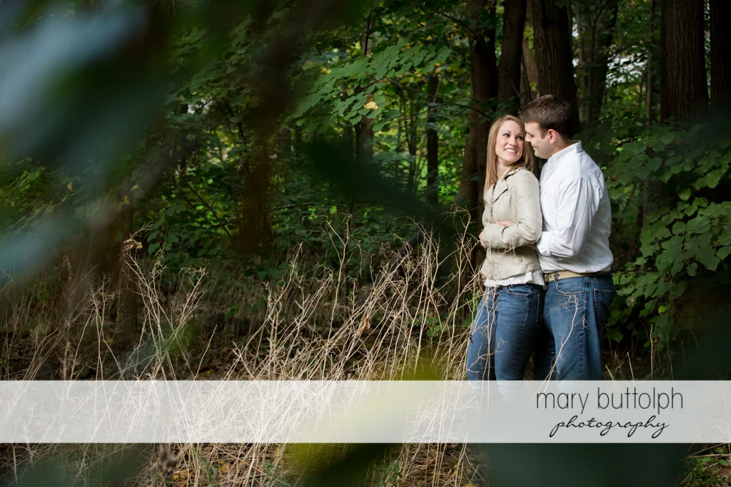 Couple take a break in the woods at Skaneateles Engagement