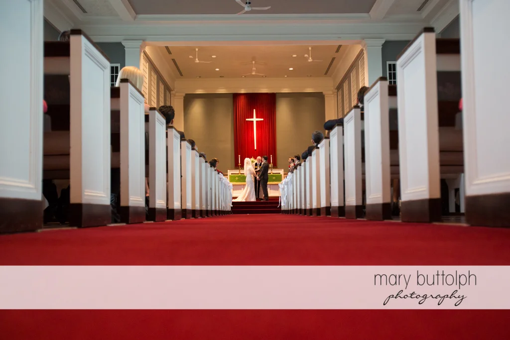 Long shot of the couple in front of the altar at Traditions at the Links Wedding