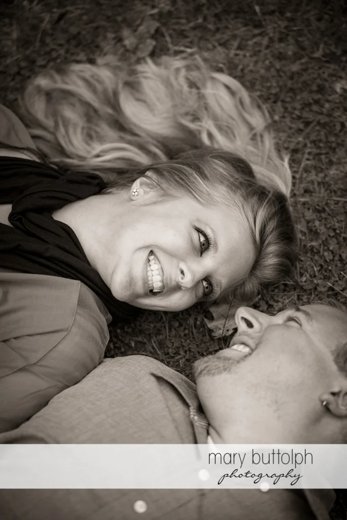 Couple lie on the grass at Watkins Glen Engagement
