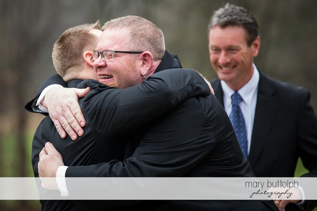 Same sex couple embrace after the wedding at Arrowhead Lodge Wedding
